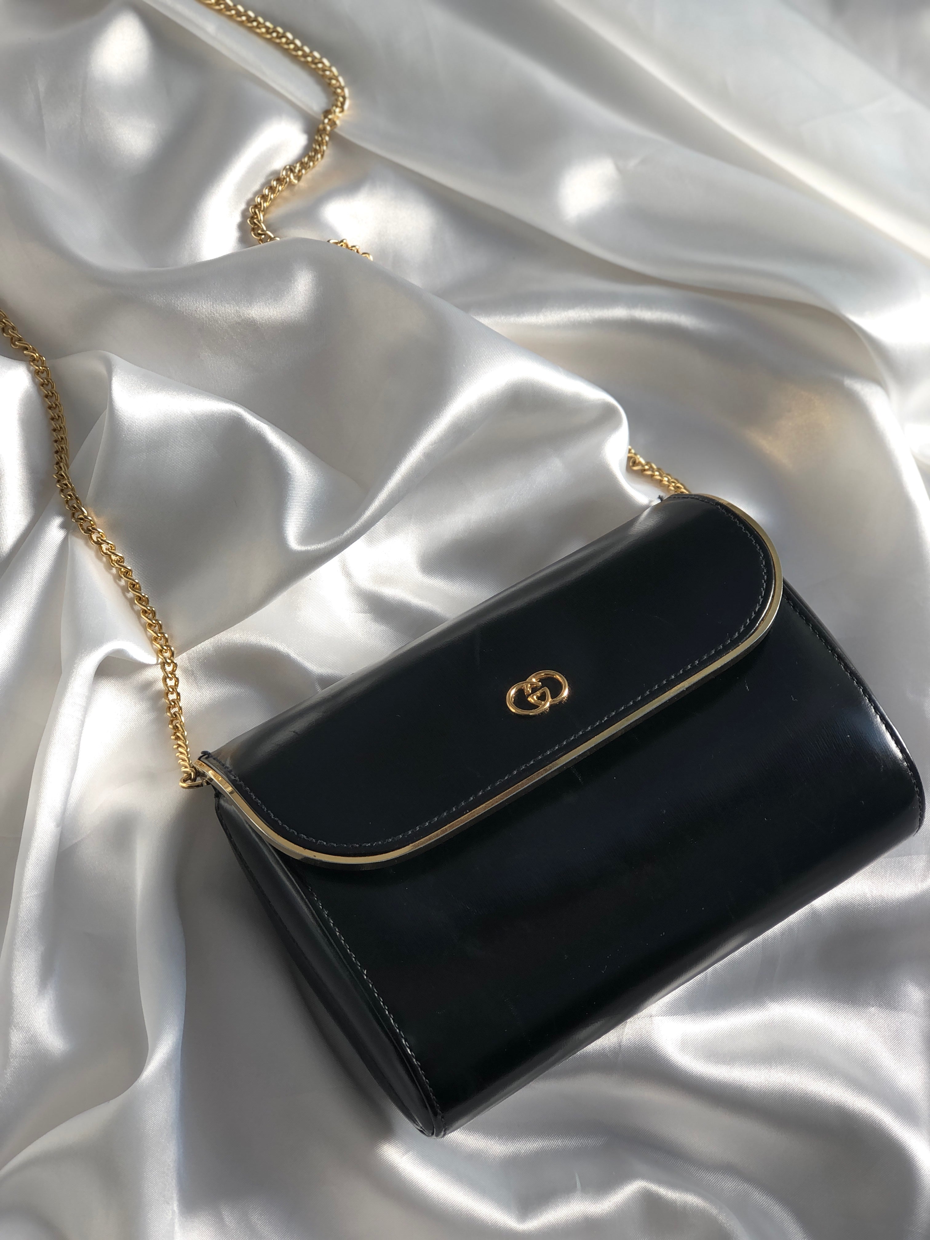 Classic black handbag with a gold chain.